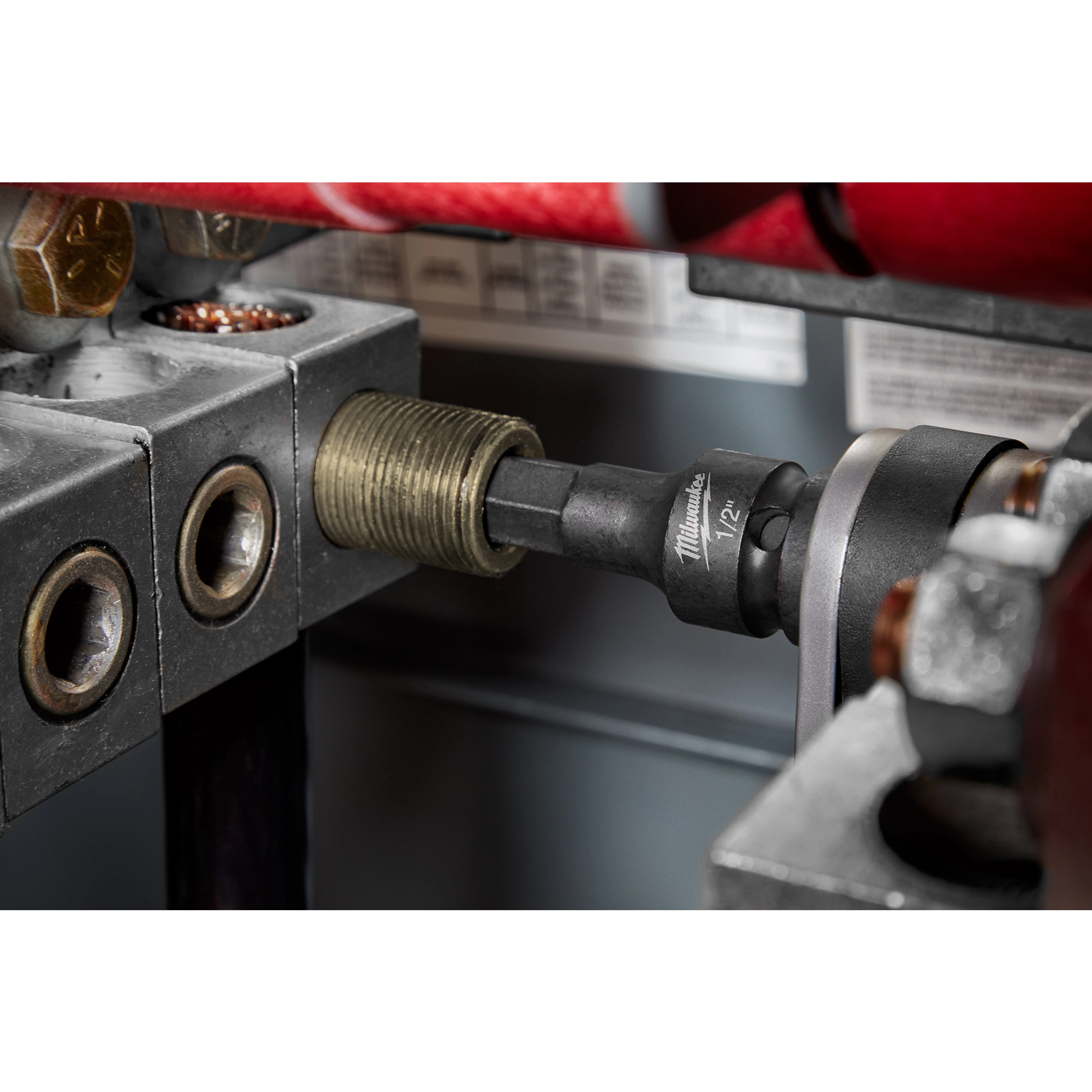 1/2" Drive 1/2" Hex Bit Socket attached to a metallic apparatus, shown in use tightening or loosening a bolt or fastener.