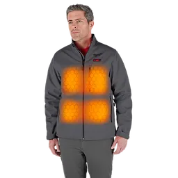 A person is wearing an M12™ Heated TOUGHSHELL™ Jacket. The jacket is gray and features highlighted heating zones on the chest and stomach areas, indicated by glowing orange hexagon patterns. The jacket has a zippered front and side pockets.