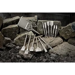 2020 Sledge Chisel Family Shot features various chisels displayed on large rocks, showcasing different shapes and sizes designed for heavy-duty tasks.