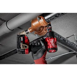 Person using a power tool with SHOCKWAVE Impact Duty 1/2" Drive 11/16" Standard 6 Point Socket to adjust plumbing pipes.