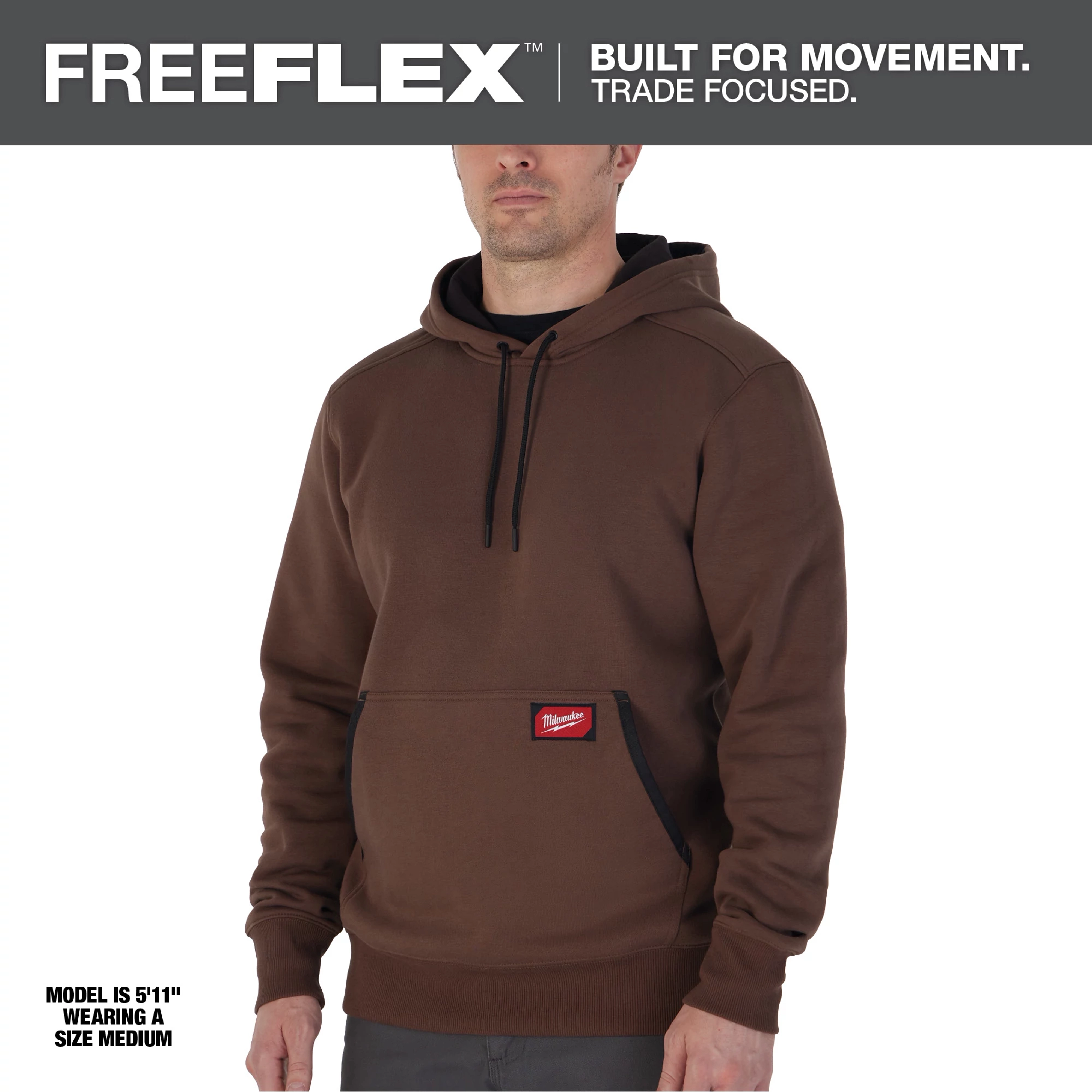 Midweight Pullover Hoodie - Brown. Model is 5'11" wearing a medium. Hoodie features kangaroo pocket, black drawstrings, and red patch logo.