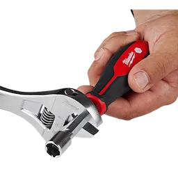 A hand holds the 1/2" HollowCore Magnetic Nut Driver using an adjustable wrench, highlighting the tool's magnetic feature.