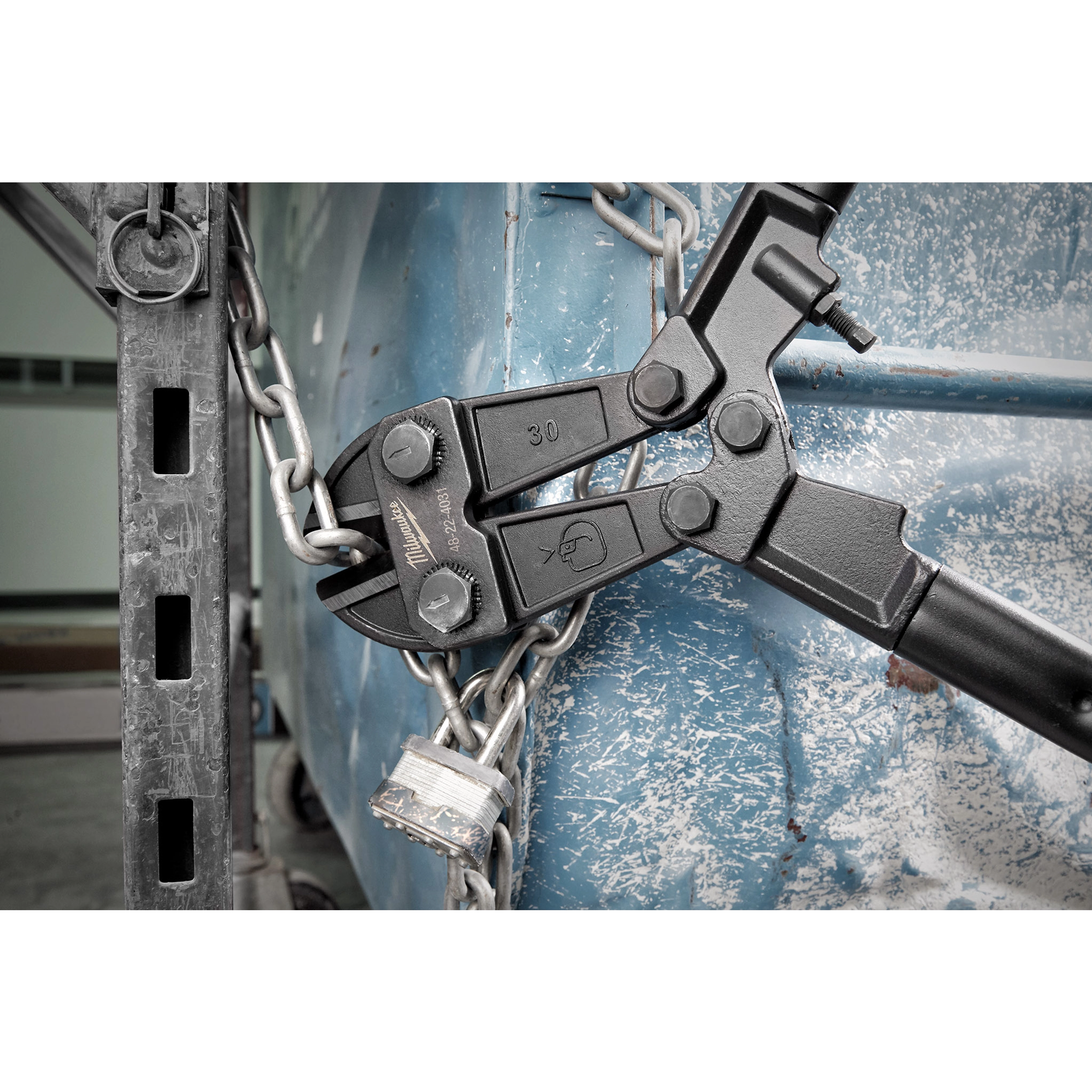 30" Bolt Cutter cutting through a thick metal chain with a padlock, showcasing its strength and cutting ability.