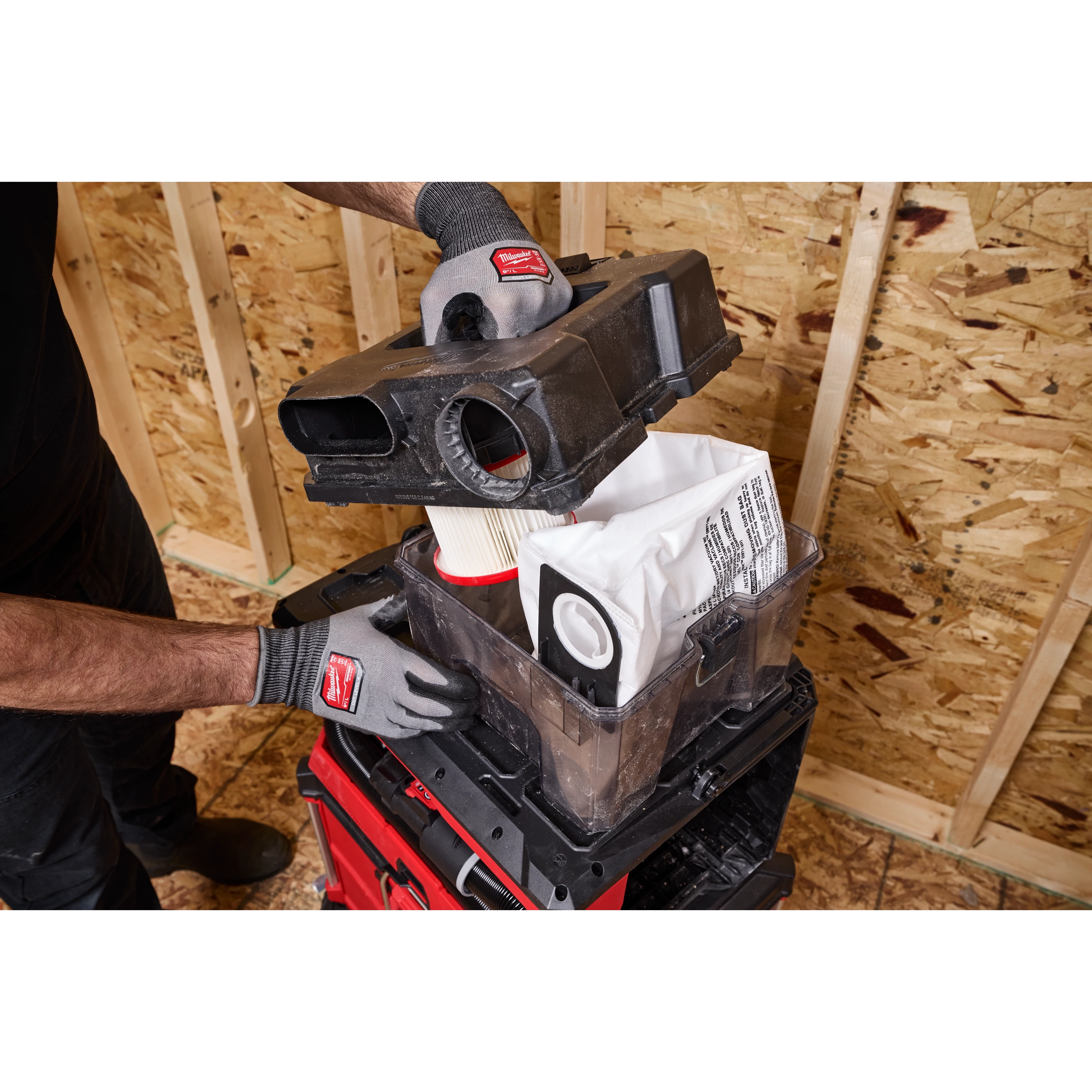 Worker opens M18 FUEL 4 Gallon Wet/Dry Vacuum w/ PACKOUT Compatibility & VACLINK to access filter and dust bag.