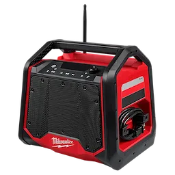 The Milwaukee M18™ Bluetooth® Jobsite Radio + Charger features a sturdy red and black design with a large speaker grille, control buttons on top, and a side compartment for cable storage. The device offers Bluetooth connectivity and charging capabilities for other devices, making it ideal for job sites.