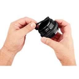 Hands holding the PACKOUT Sip Lid, a black, cylindrical lid with a small spout, designed for easy drinking and security.