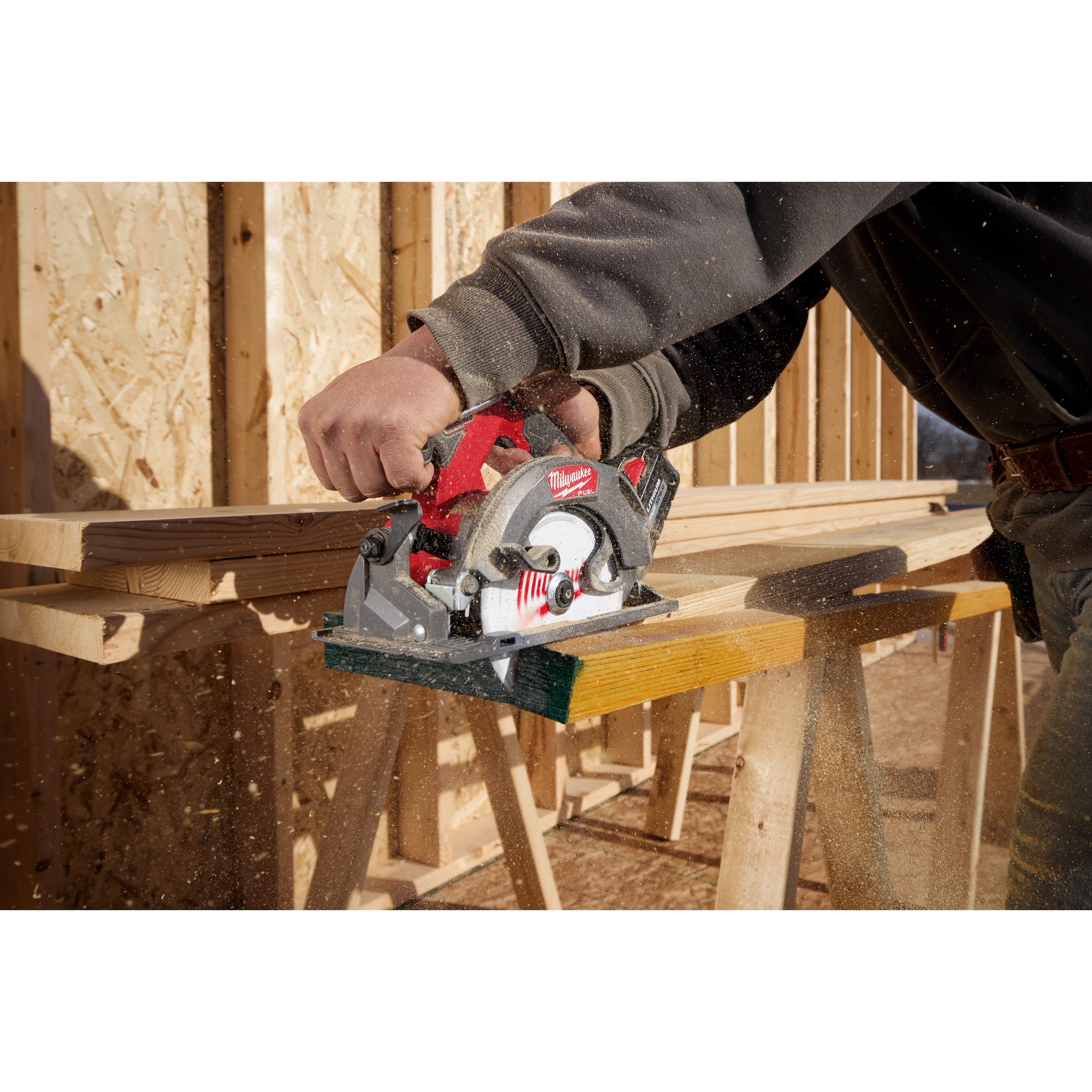 Image of a worker using the Milwaukee M18 FUEL 6-1/2" Circular Saw on a jobsite to cut wood