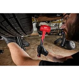 Worker using the 48oz Dead Blow Hammer for automotive use