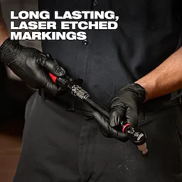 A person wearing black gloves holds a 3/8” Drive Click Torque Wrench (20-100 ft·lbf) featuring long-lasting, laser-etched markings.