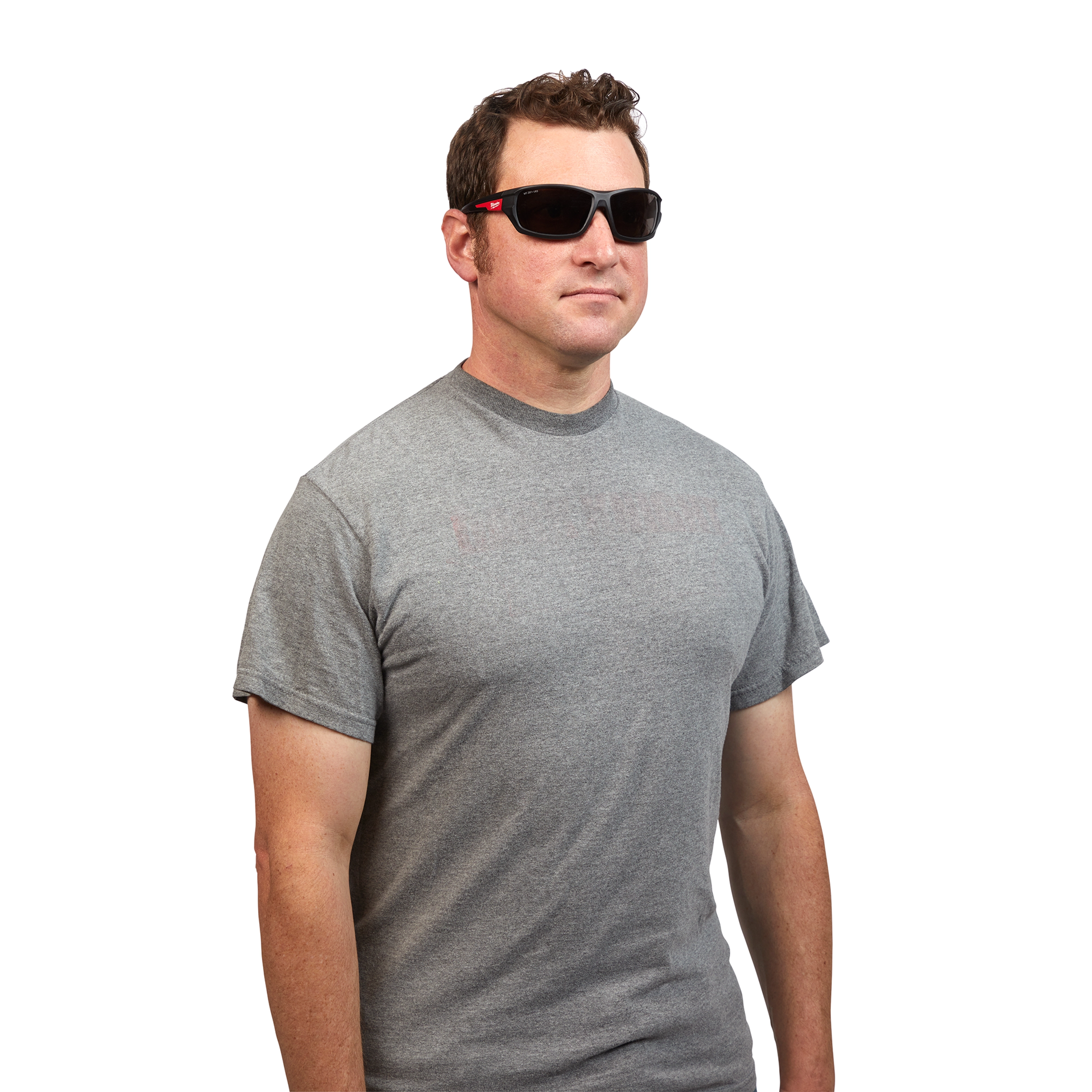 Man is wearing Performance Safety Glasses – Tinted Fog-Free Lenses and a gray t-shirt. The glasses are black with side protection.