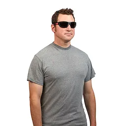 Man is wearing Performance Safety Glasses – Tinted Fog-Free Lenses and a gray t-shirt. The glasses are black with side protection.
