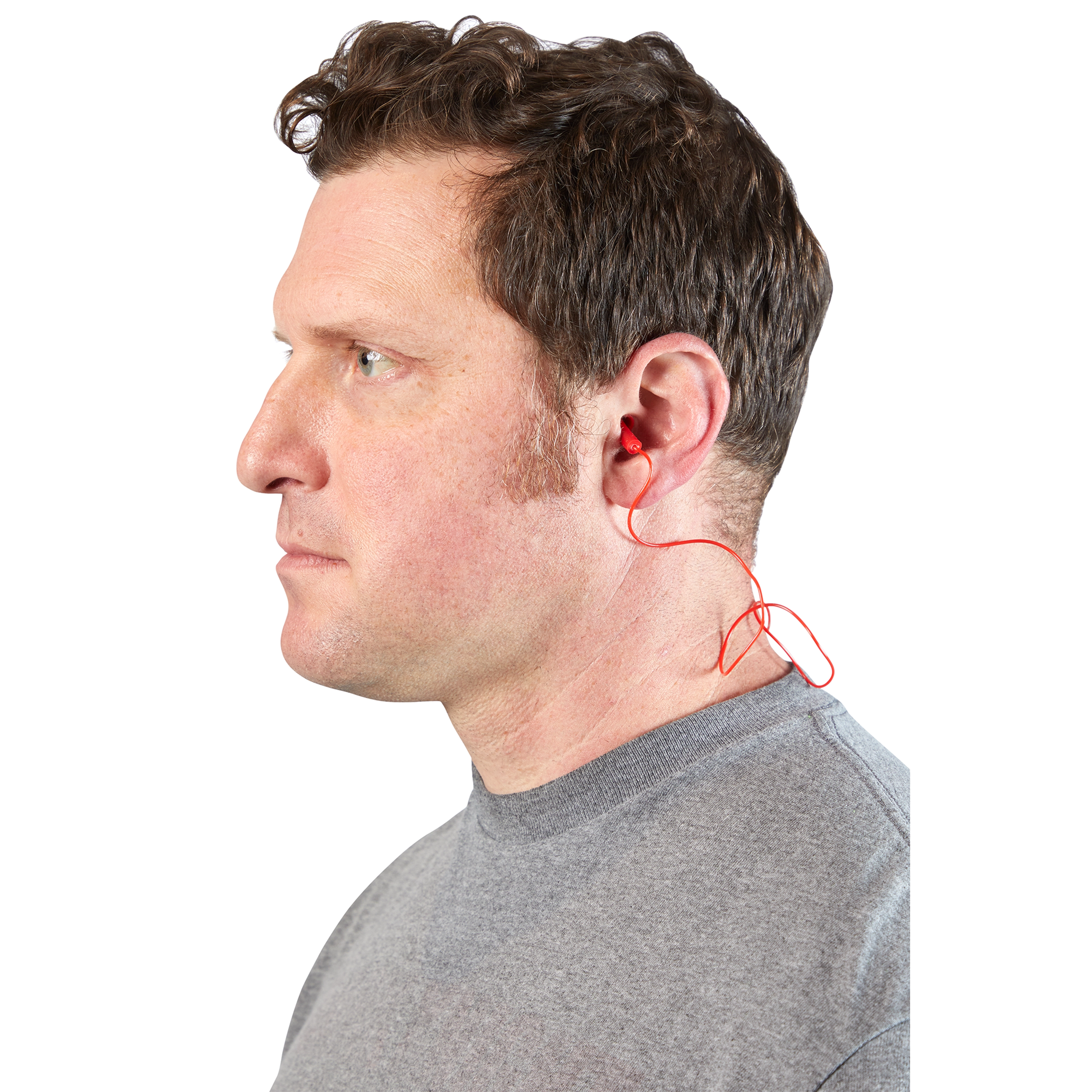 A person wearing red Corded Ear Plugs, with the cord visible behind the ear and a grey shirt.