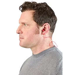 A person wearing red Corded Ear Plugs, with the cord visible behind the ear and a grey shirt.