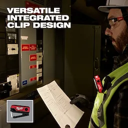 Worker wearing a vest uses a Milwaukee laser level clipped to their chest while reading a document.