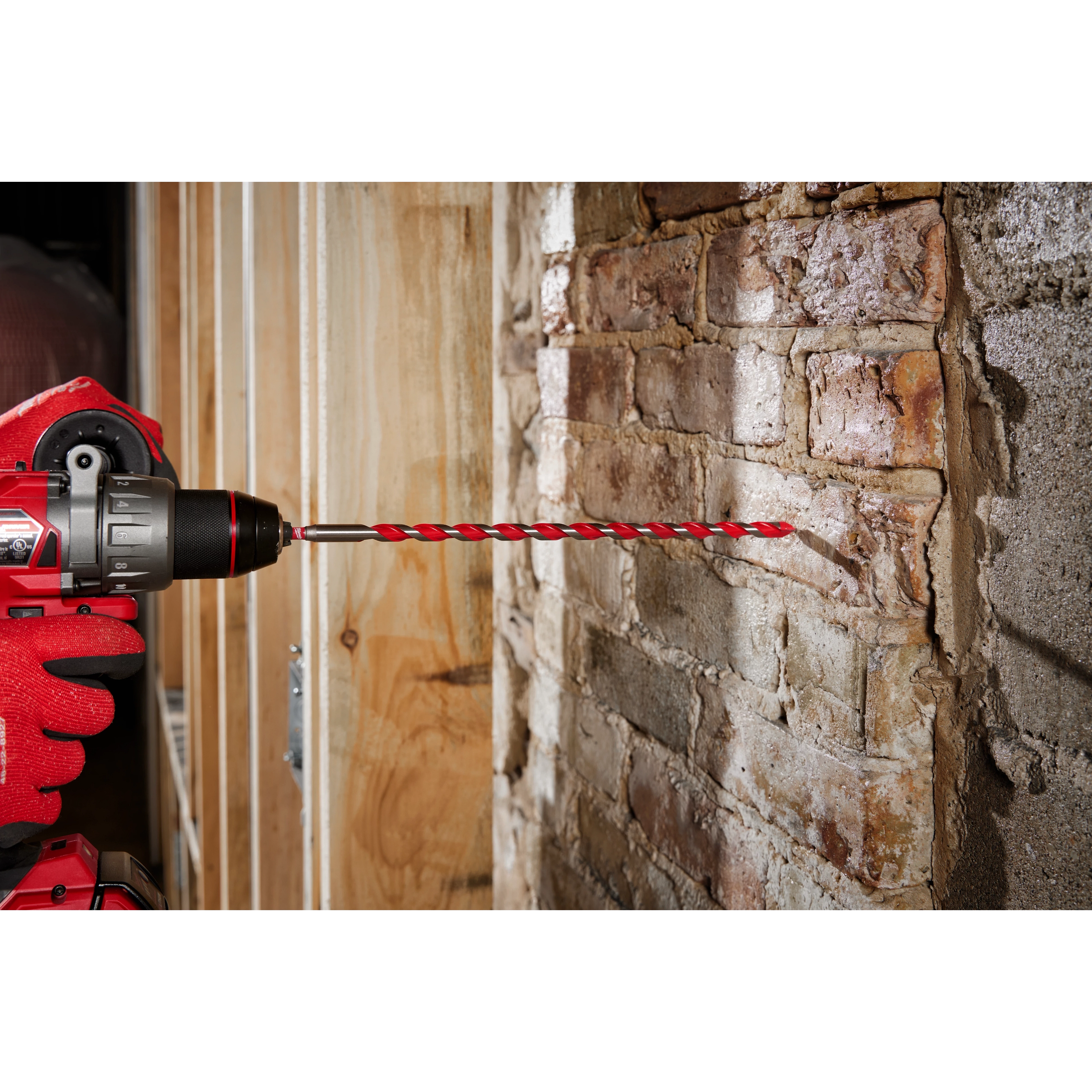 Cordless drill using a 3/8" x 10" x 12" SHOCKWAVE Impact Duty Carbide Hammer Drill Bit to drill into a brick wall.