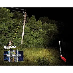 M18 ROCKET Dual Pack Tower Light with ONE-KEY illuminating a worker near a power pole at night in a dense forested area. 
