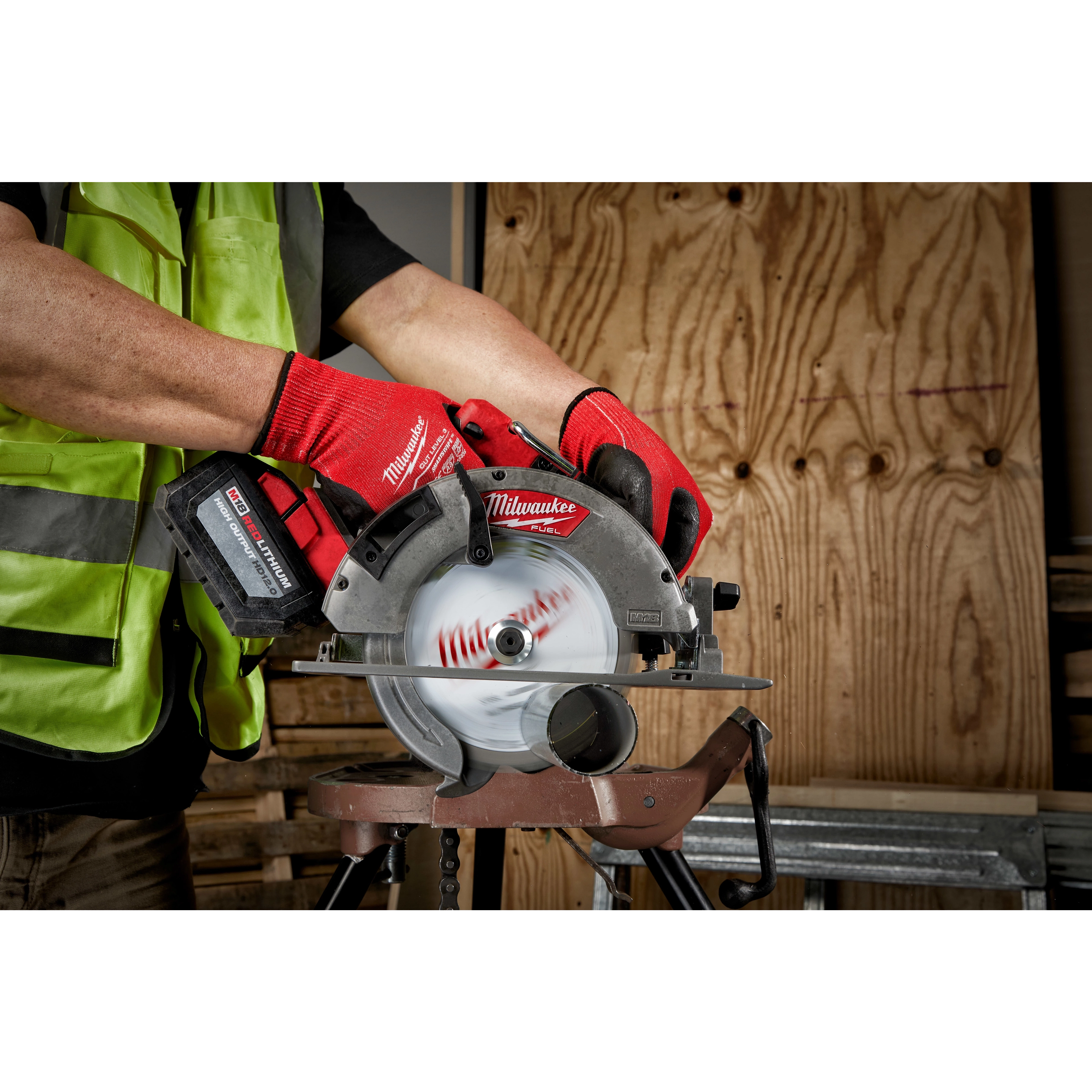 Worker using a 7-1/4" Metal Cutting Circular Saw Blade, 5/8" Arbor, on a saw for cutting metal sheets in a workshop.