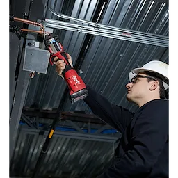 A person uses the M18 FORCE LOGIC Press Tool Kit with One-Key and 1/4"-7/8" Streamline ACR Jaws to fix a pipe overhead.