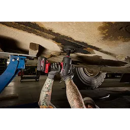 Arms using an M18 FUEL 3/4" High Torque Impact Wrench w/ ONE-KEY under a raised vehicle.