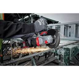 Person using the M18 FUEL 4-1/2" - 6" Braking Grinder Paddle Switch, No-Lock to cut a metal rod, wearing safety gloves.