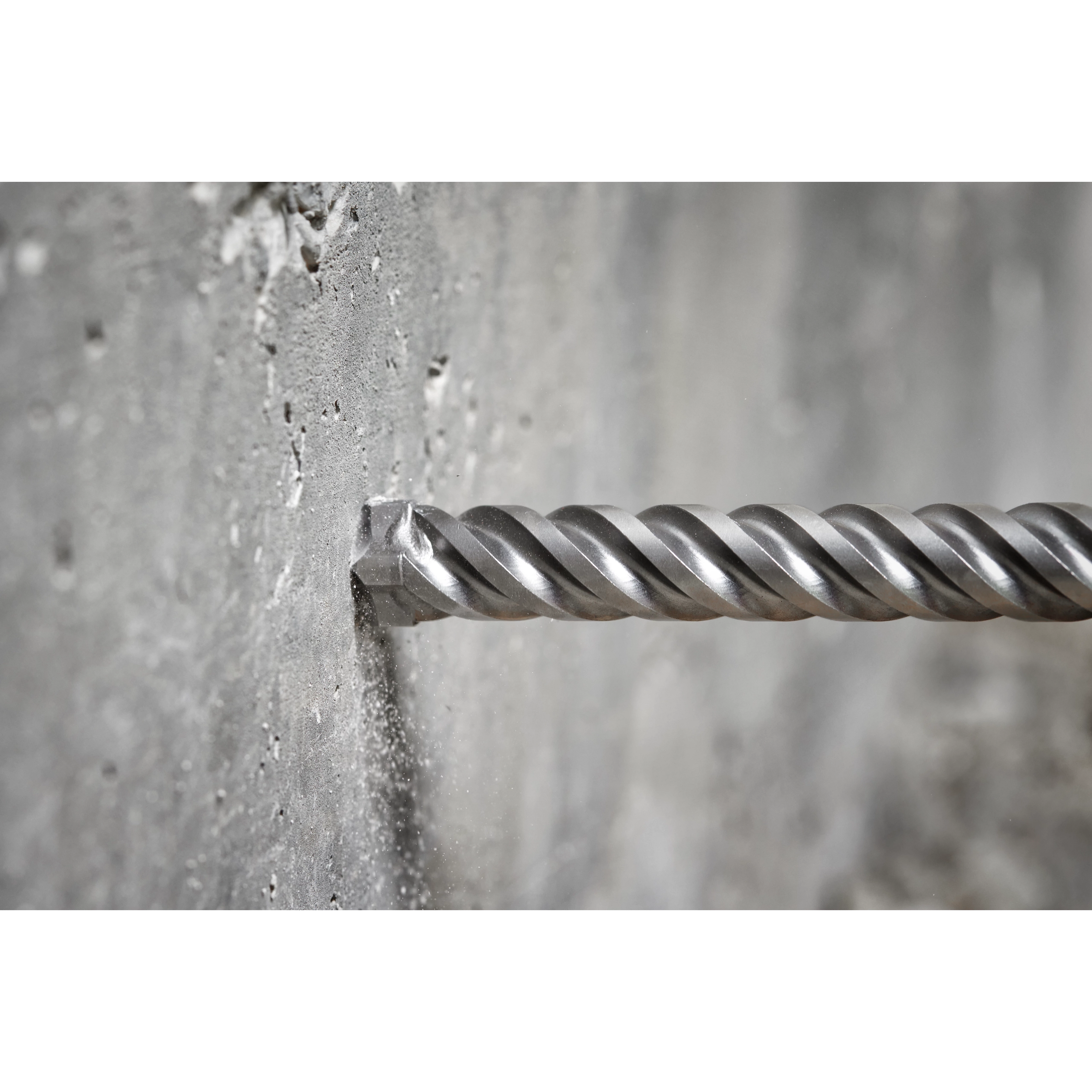 The MILWAUKEE® MX4™ 4-Cutter SDS MAX Rotary Hammer Drill Bits 3/4" X 8" X 13" drilling into a concrete wall