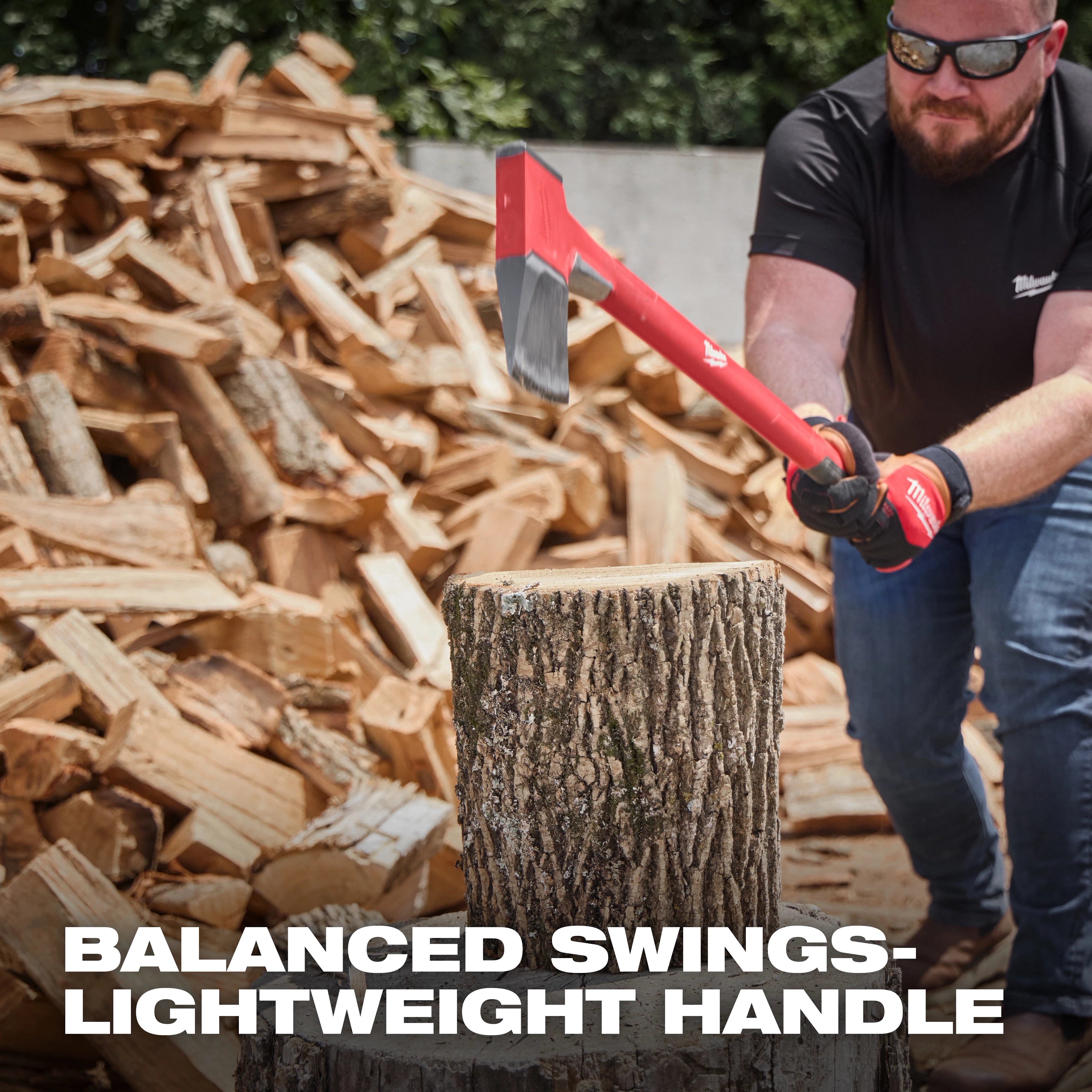 36" Splitting Axe in use, striking a log atop a stump with a pile of chopped wood in the background. Text reads: "Balanced Swings - Lightweight Handle."
