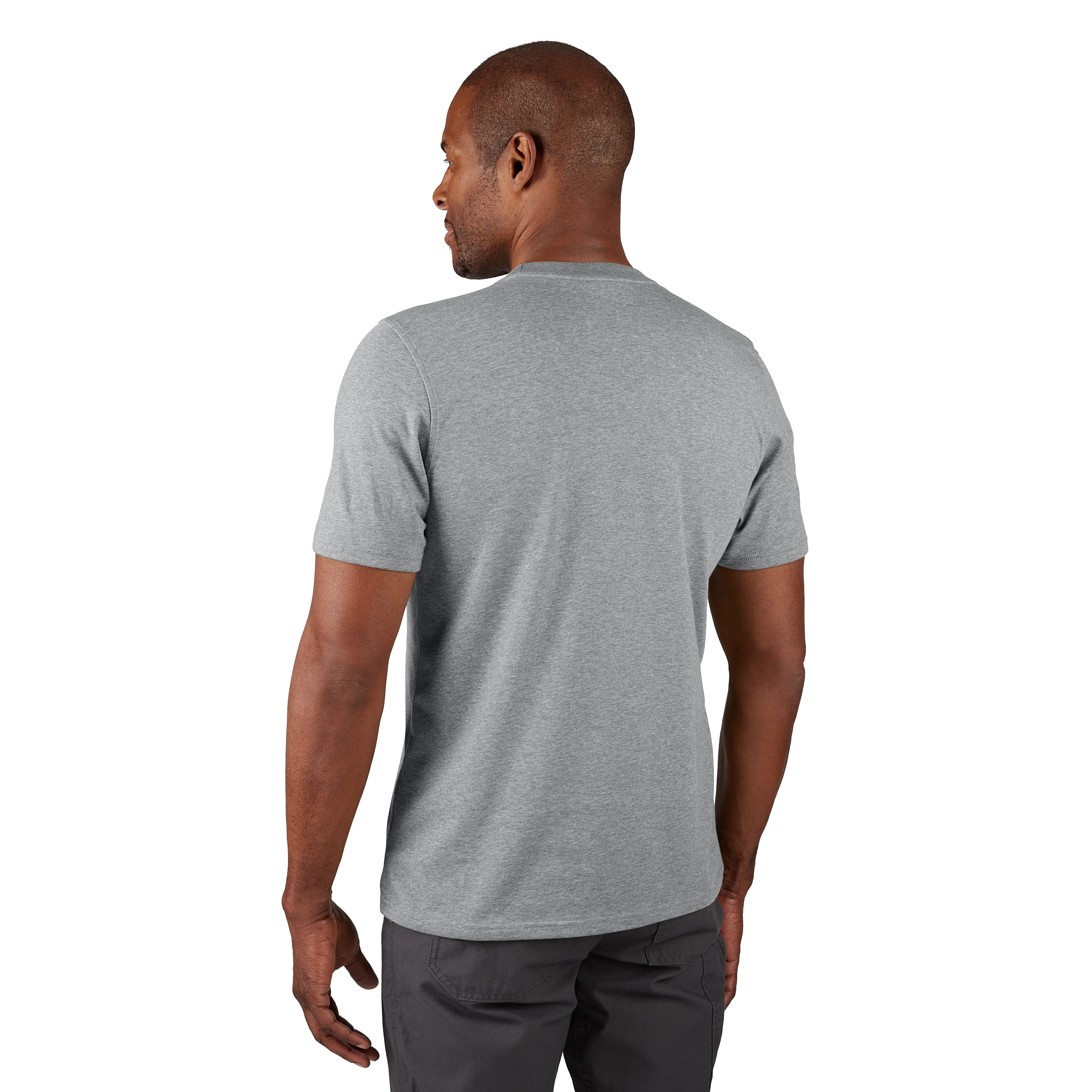 A man models the back view of the FREEFLEX Hybrid Work Tee - Short Sleeve in light gray, paired with dark gray pants.